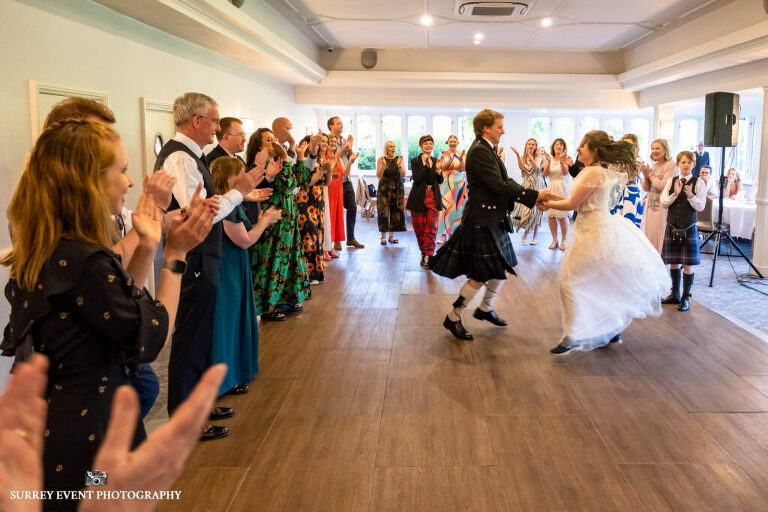 Documentary wedding photography in Surrey at a Scottish ceilidh